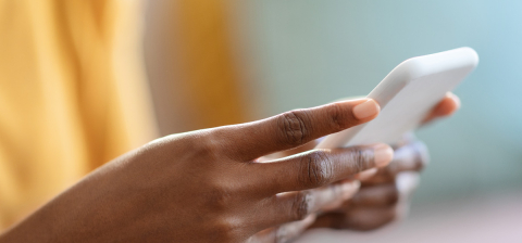 woman's hands holding a cell phone