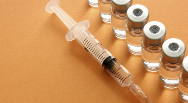 syringe and vaccine vials